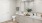 a bathroom with white cabinets